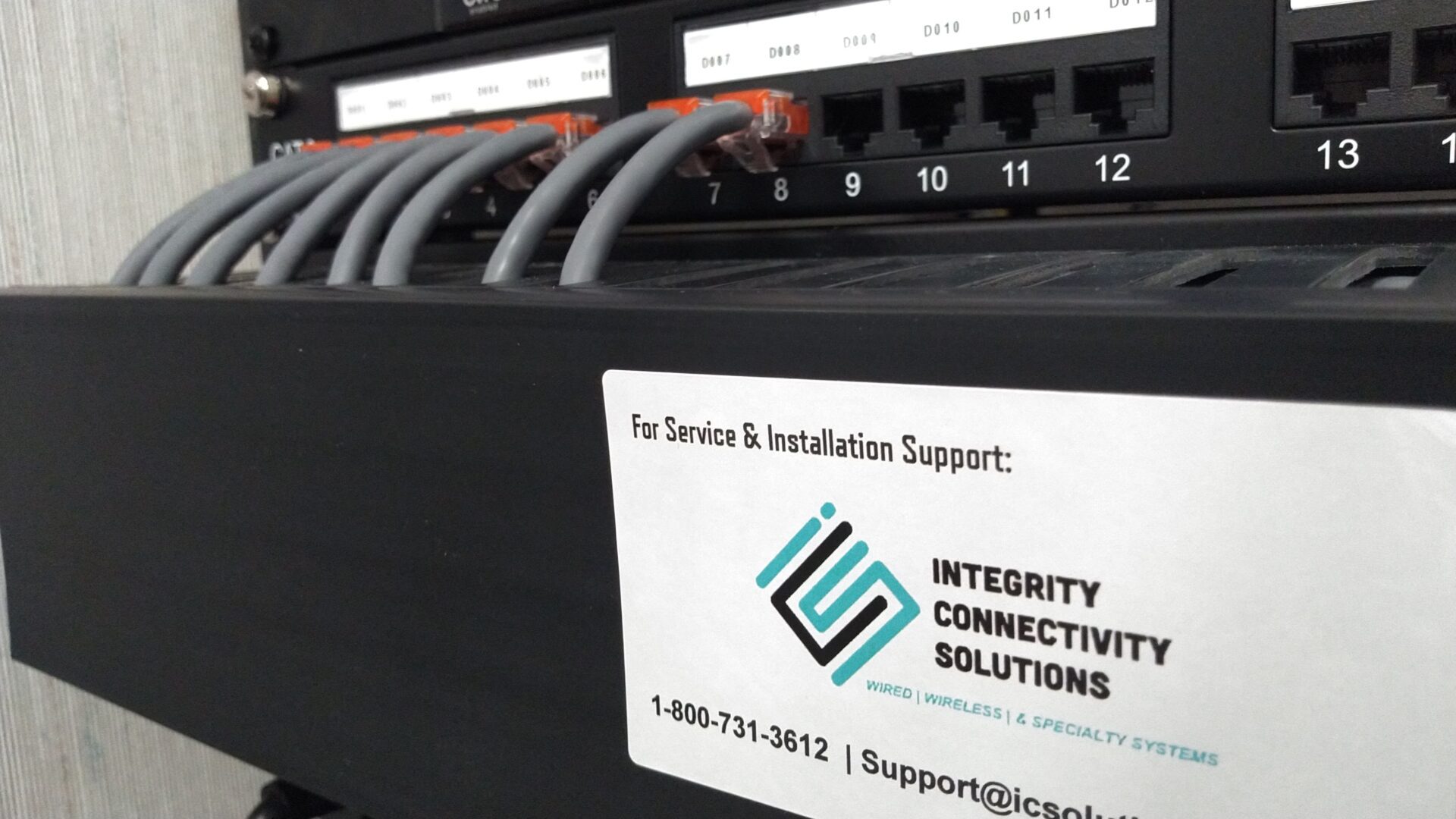 A network switch with cables and a support card for Integrity Connectivity Solutions.