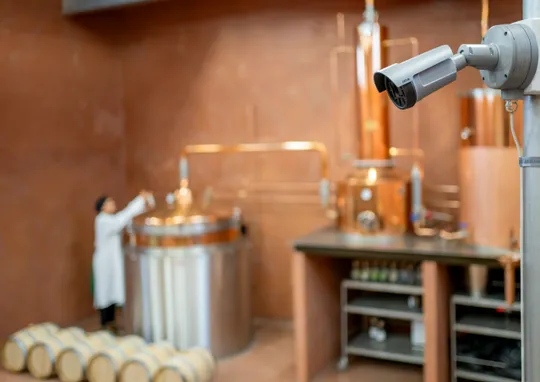 Scientist working with distillation equipment in a lab.
